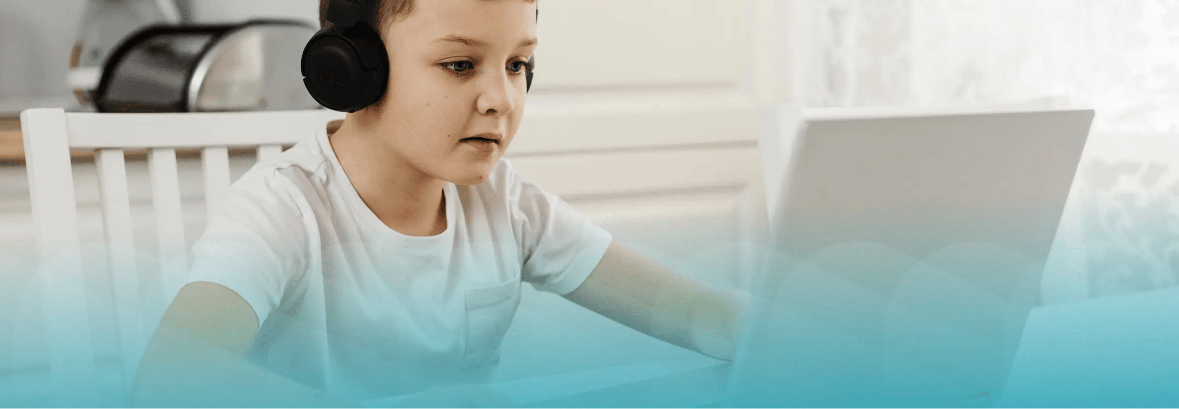 Young student working on computer from home. Blue filter on top of image.